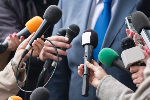 Press conference interview. journalists flocking around important person, politician or businessman